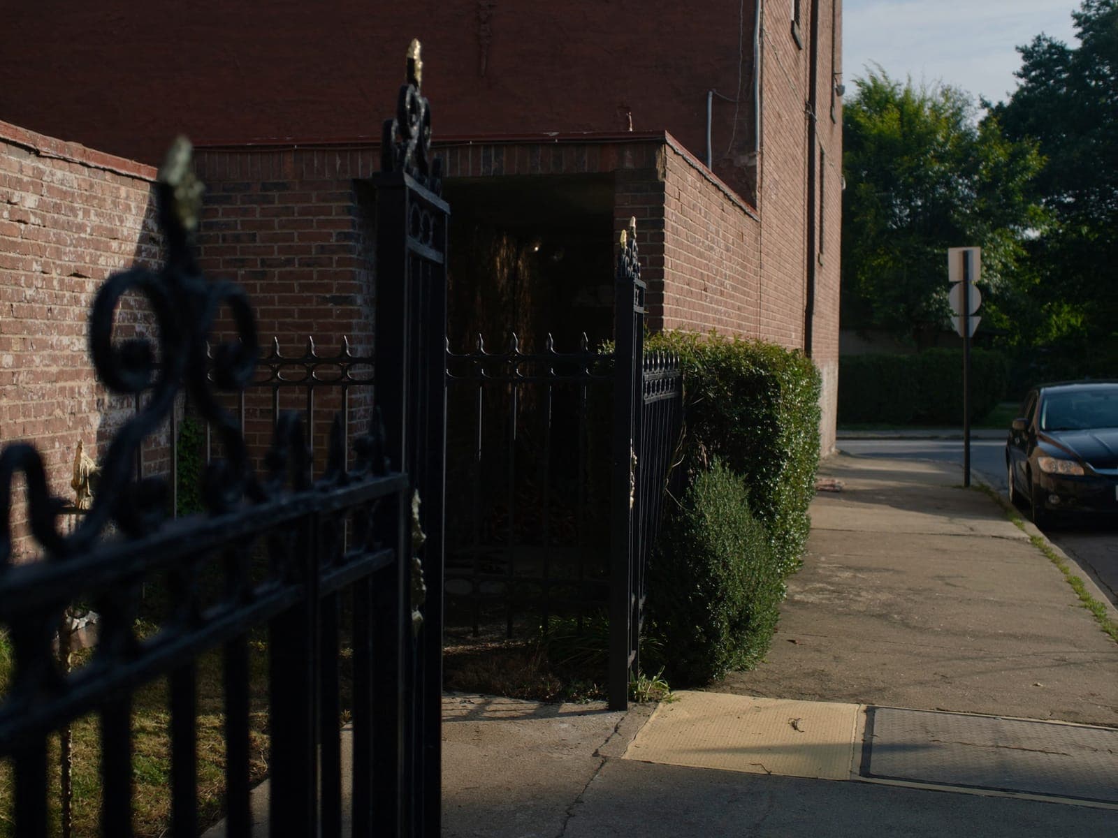 Black iron gate and sidewalk outside the Cattano Avenue visitor entrance